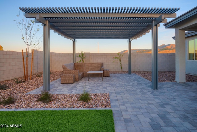 patio terrace at dusk with a pergola and outdoor lounge area