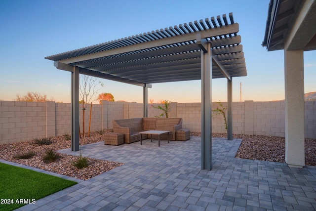 patio terrace at dusk featuring an outdoor living space and a pergola