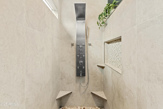 interior details featuring a tile shower