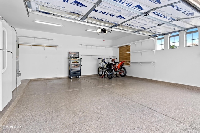 garage featuring baseboards and a garage door opener