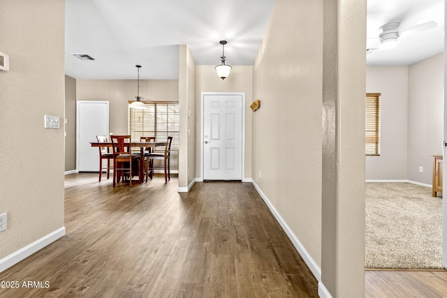 entrance foyer with wood finished floors, visible vents, and baseboards