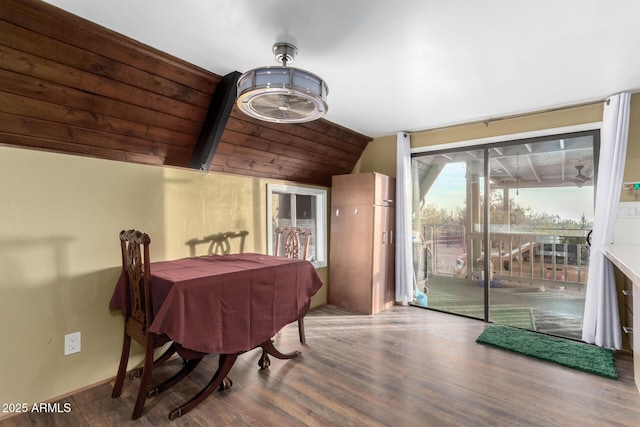 dining room featuring wood finished floors and lofted ceiling