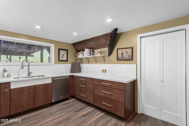kitchen featuring dark wood-style flooring, dishwasher, light countertops, and a sink