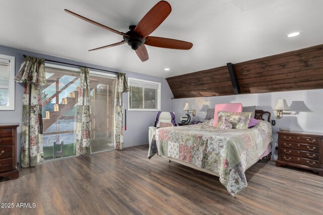 bedroom with access to exterior, multiple windows, and wood finished floors