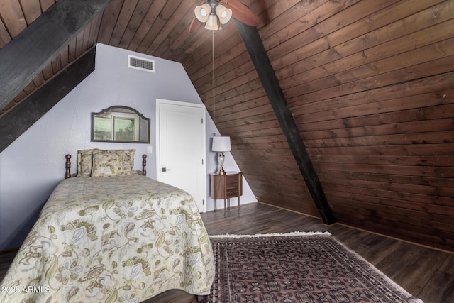 unfurnished bedroom with visible vents, vaulted ceiling with beams, wooden ceiling, and wood finished floors