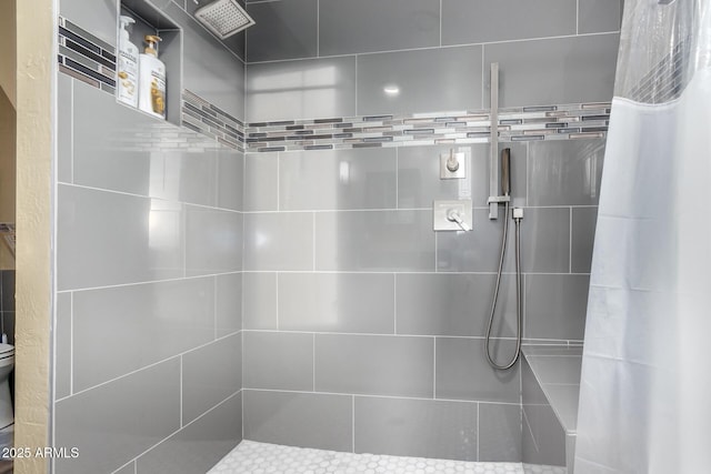 full bath featuring tiled shower