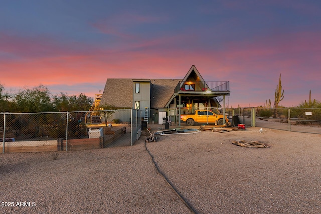 a-frame style home featuring fence and a gate