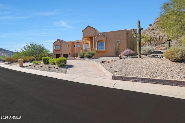 southwest-style home with a mountain view and a garage