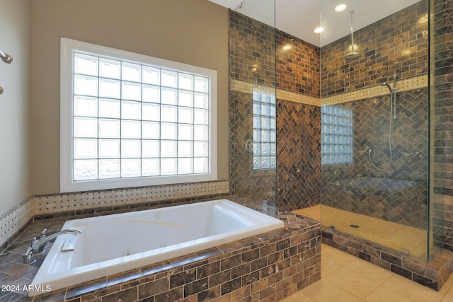 bathroom featuring tile patterned flooring and separate shower and tub