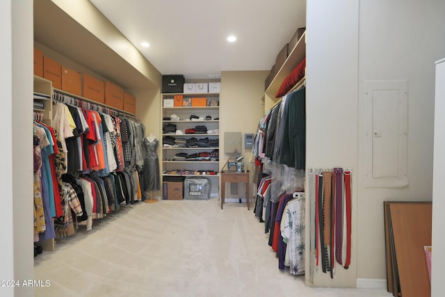 walk in closet featuring electric panel and light carpet