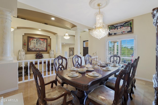 dining room featuring ornate columns and an inviting chandelier