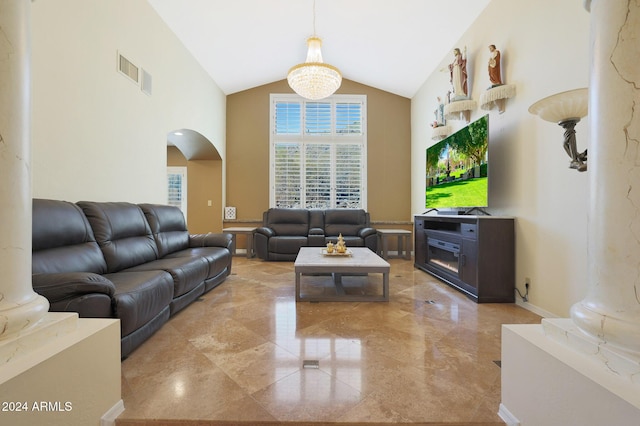 living room with high vaulted ceiling and a chandelier