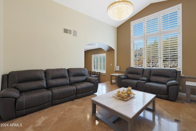 living room featuring an inviting chandelier and lofted ceiling