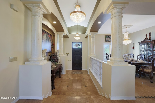 entrance foyer with vaulted ceiling and an inviting chandelier