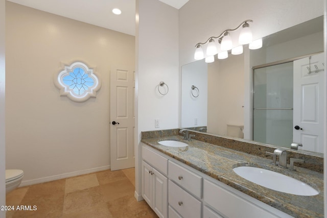 bathroom with vanity, an enclosed shower, and toilet