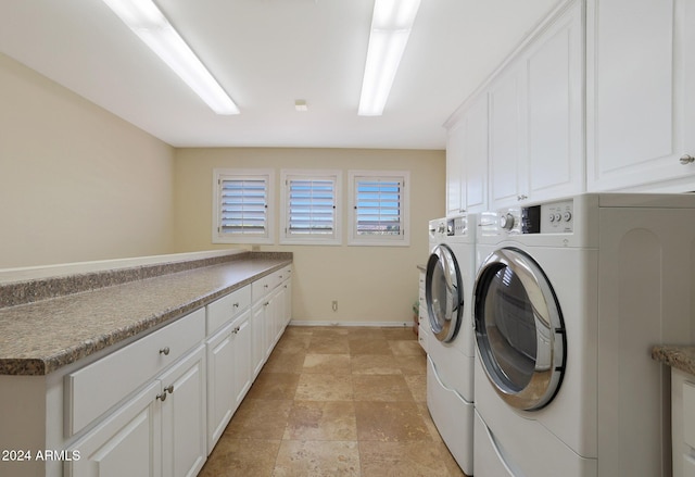 clothes washing area featuring cabinets and washing machine and clothes dryer