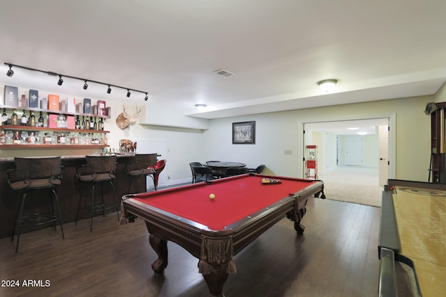 rec room with bar, dark hardwood / wood-style flooring, track lighting, and billiards