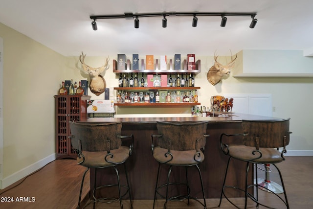 bar featuring dark hardwood / wood-style floors