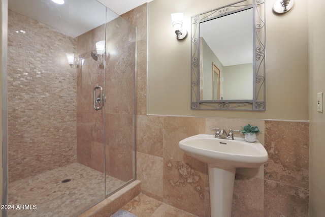 bathroom with an enclosed shower and tile walls