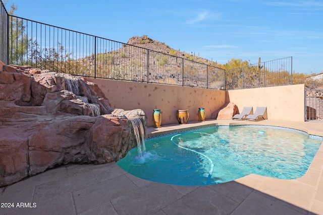 view of pool with pool water feature