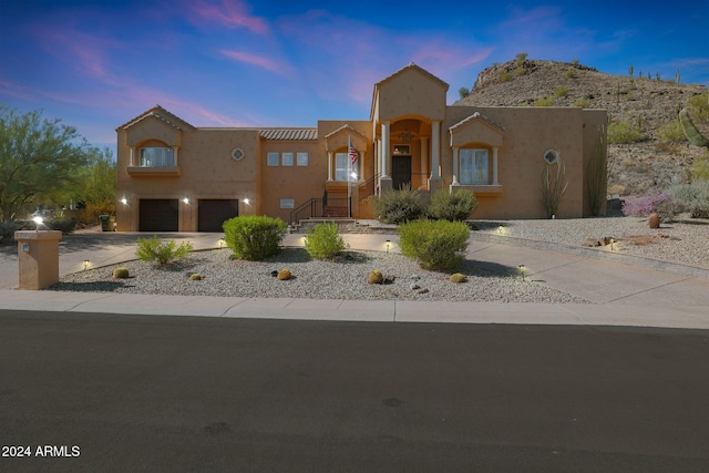 pueblo revival-style home with a garage