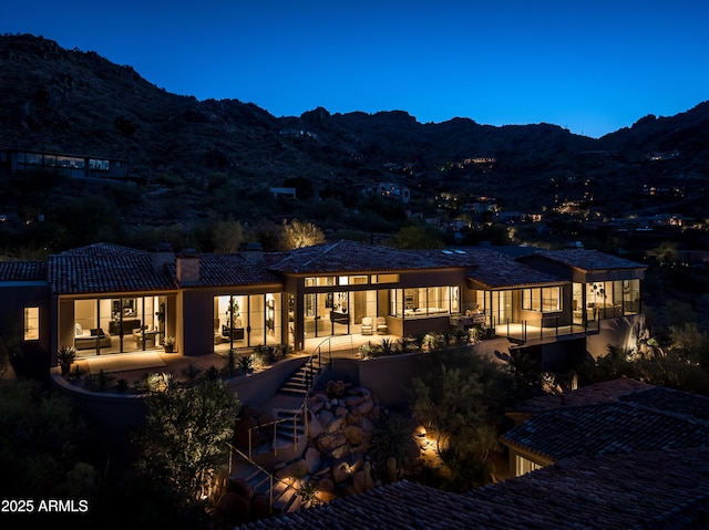 back of house featuring a mountain view and a patio area