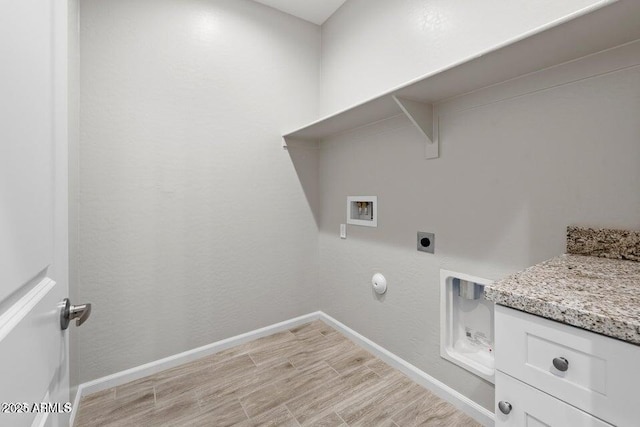 laundry area with light wood-type flooring, hookup for an electric dryer, gas dryer hookup, and washer hookup