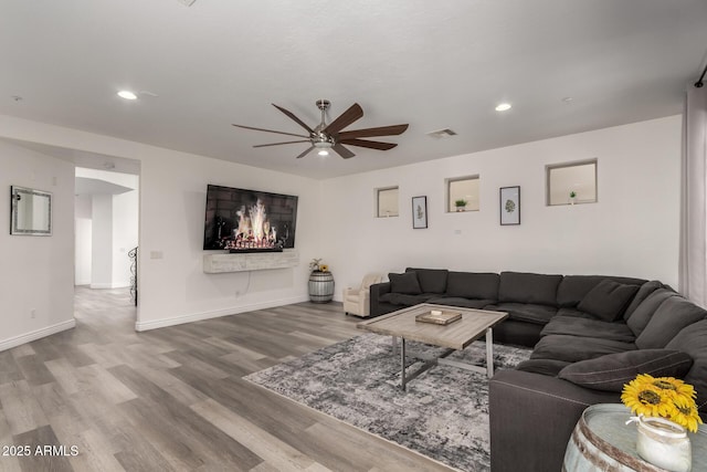 living area with visible vents, recessed lighting, baseboards, and wood finished floors