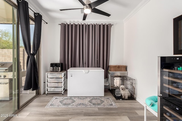 bedroom with wood finished floors, baseboards, ornamental molding, access to exterior, and wine cooler