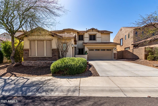 view of front of property featuring fence, concrete driveway, stucco siding, stone siding, and an attached garage