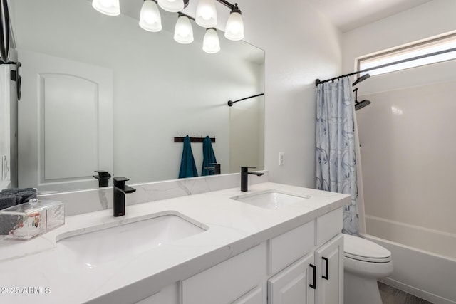 full bathroom with double vanity, toilet, shower / bath combo with shower curtain, and a sink