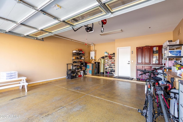 garage featuring water heater and a garage door opener