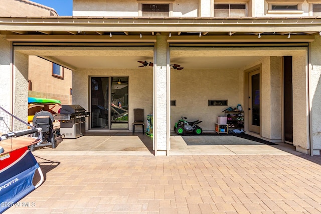 doorway to property with a patio area and stucco siding