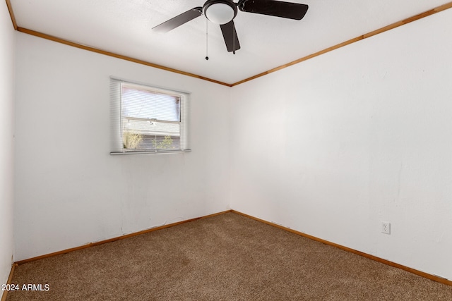 carpeted empty room featuring ceiling fan and ornamental molding