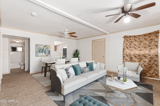 living room with crown molding, beamed ceiling, light colored carpet, and ceiling fan