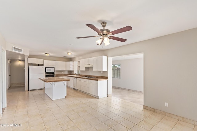 18402 N 17th Ave, Phoenix, AZ 85023 - kitchen featuring white appliances, a sink, white cabinets, a kitchen island, and a ceiling fan