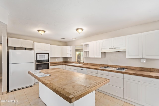 18402 N 17th Ave, Phoenix, AZ 85023 - kitchen with white appliances, under cabinet range hood, white cabinetry, and light tile patterned floors