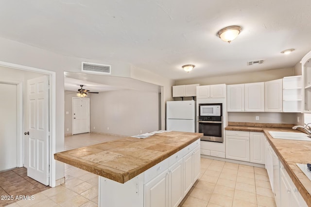 18402 N 17th Ave, Phoenix, AZ 85023 - kitchen featuring white appliances, a sink, light tile patterned flooring, and white cabinetry
