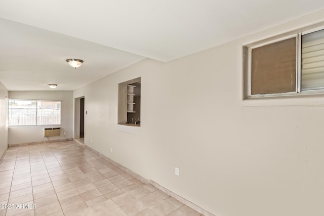 18402 N 17th Ave, Phoenix, AZ 85023 - spare room featuring an AC wall unit, light tile patterned floors, and baseboards