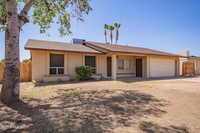 18402 N 17th Ave, Phoenix, AZ 85023 - ranch-style home featuring fence, a garage, dirt driveway, and stucco siding