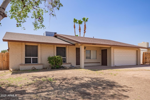 18402 N 17th Ave, Phoenix, AZ 85023 - ranch-style house featuring fence, a garage, dirt driveway, and stucco siding