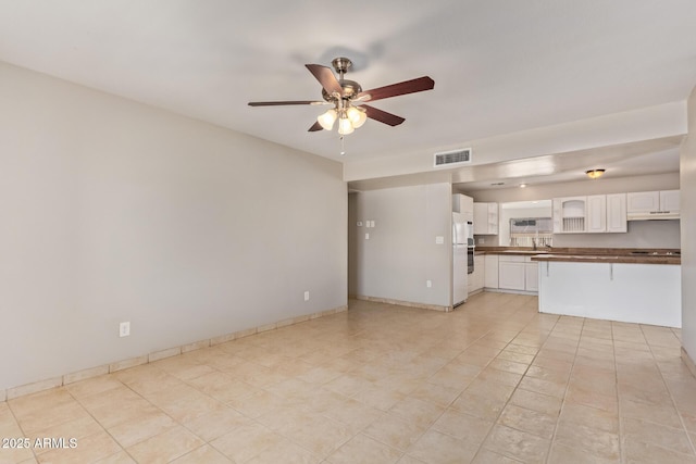 18402 N 17th Ave, Phoenix, AZ 85023 - unfurnished living room featuring a ceiling fan, light tile patterned floors, and baseboards