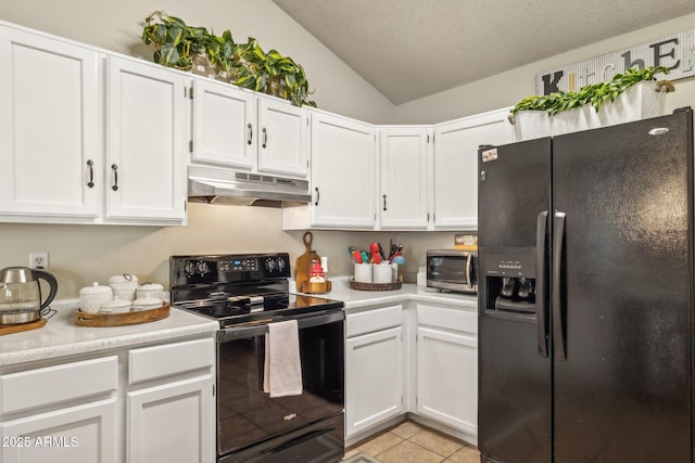 kitchen with white cabinetry, vaulted ceiling, light tile patterned floors, and black appliances