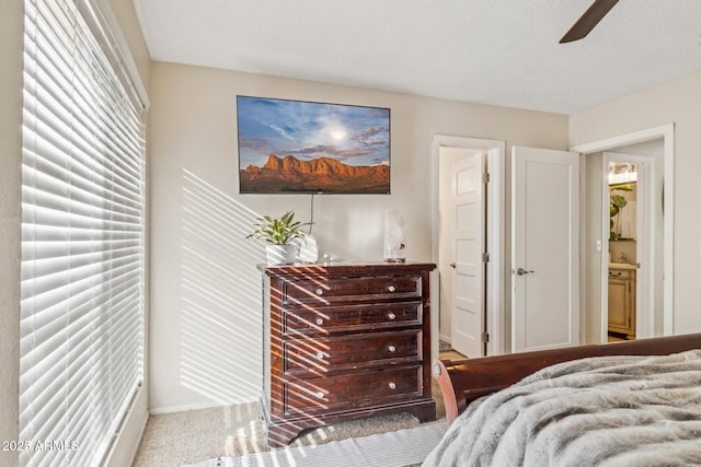 bedroom featuring light colored carpet and ceiling fan