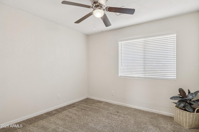 carpeted spare room with ceiling fan