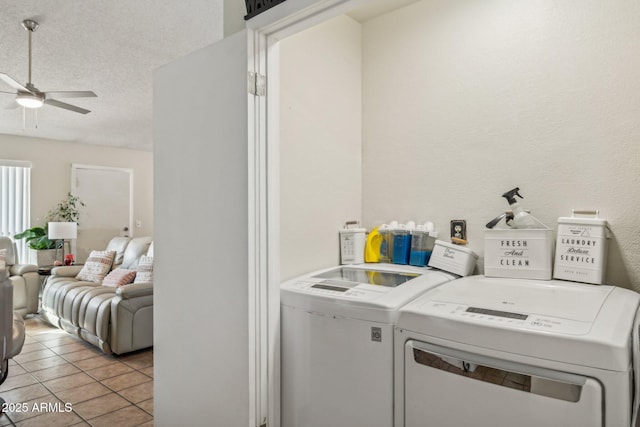 washroom featuring light tile patterned flooring, ceiling fan, separate washer and dryer, and a textured ceiling