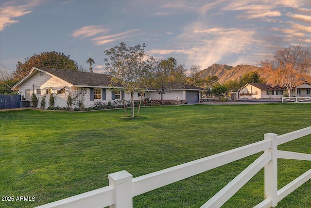 view of front facade featuring a mountain view and a yard