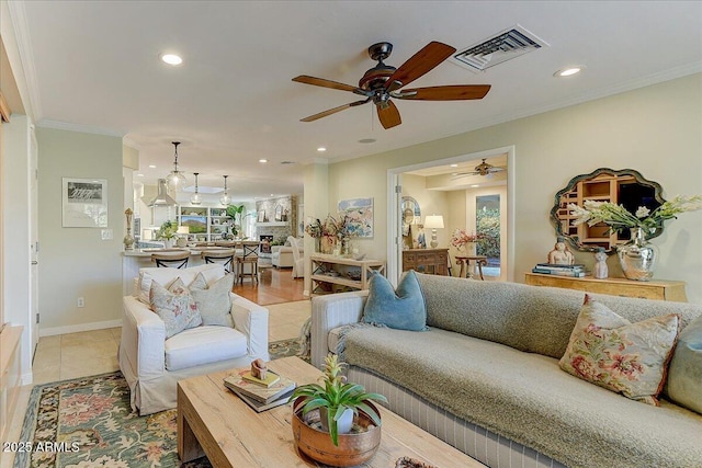 tiled living room featuring ceiling fan and ornamental molding