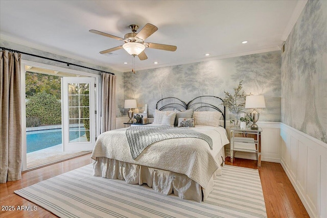 bedroom featuring ceiling fan, crown molding, light hardwood / wood-style flooring, and access to outside