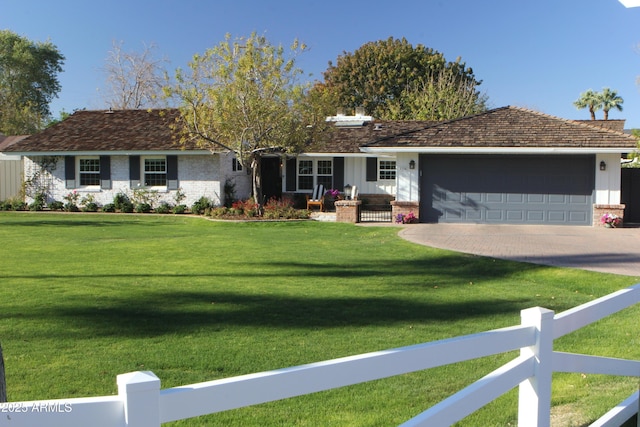 single story home featuring a front lawn and a garage